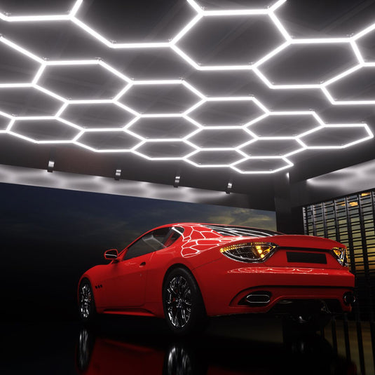 Garage ceiling with hexagon lights above a red car