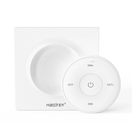 White mini remote control on its magnetic plate