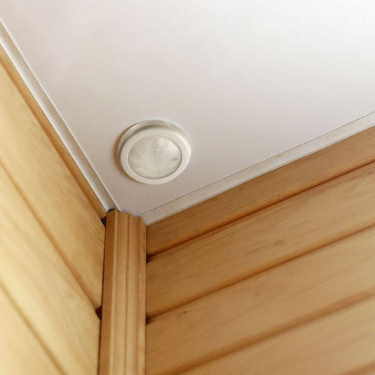 White recessed PIR sensor fitted in a ceiling