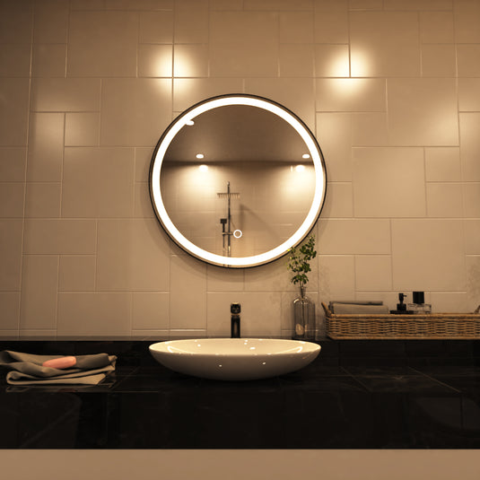 Aurora, Round LED Bathroom Mirror, 610mm - Matte Black front facing shot above sink in warm white light