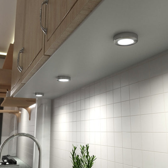 Several surface mounted LED cabinet lights with a natural white glow