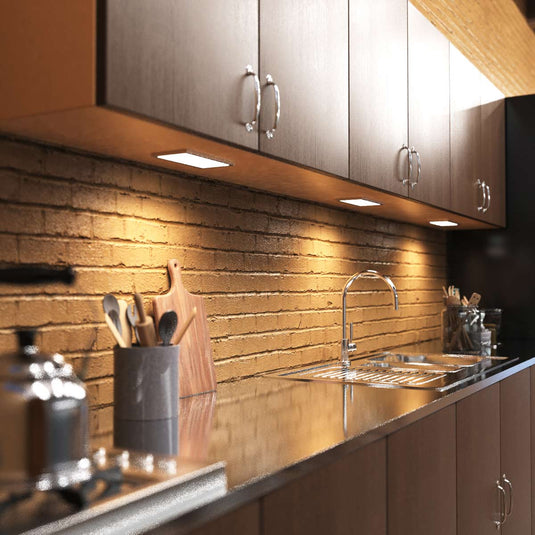Kitchen counter lit by cabinet lights, full view