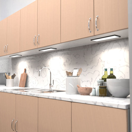 Kitchen counter lit by natural white cabinet lights, full view