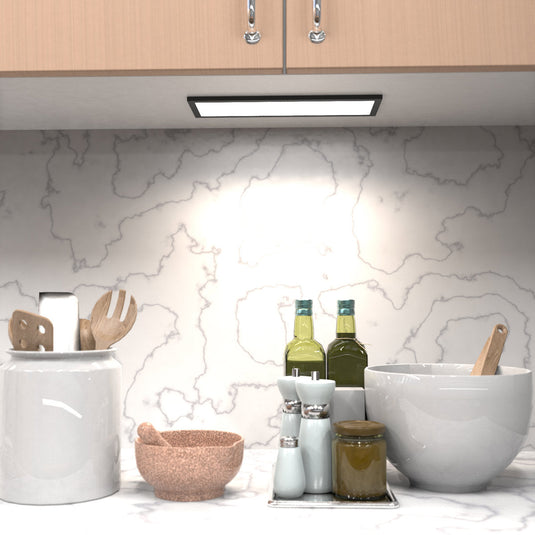 Kitchen counter lit by natural white cabinet lights