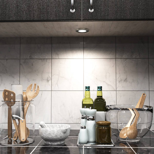 Kitchen counter lit by natural white cabinet lights