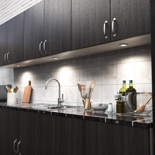 Kitchen counter lit by cabinet lights, full view