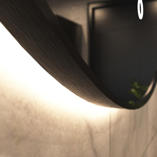 Luxe, 600mm LED Bathroom Mirror - Brushed Black close up shot on the frame, in warm white light