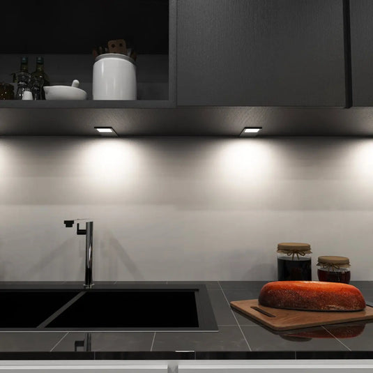 Black Recti Superslim 5w LED Cabinet Light, above the sink setting in natural white light