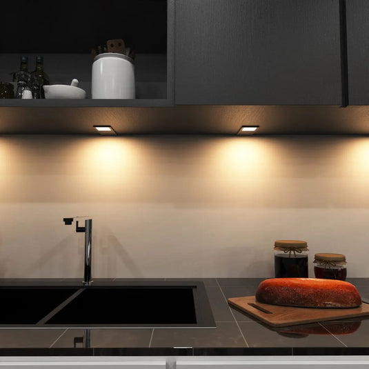 Black Recti Superslim 5w LED Cabinet Light, above the sink setting in warm white light