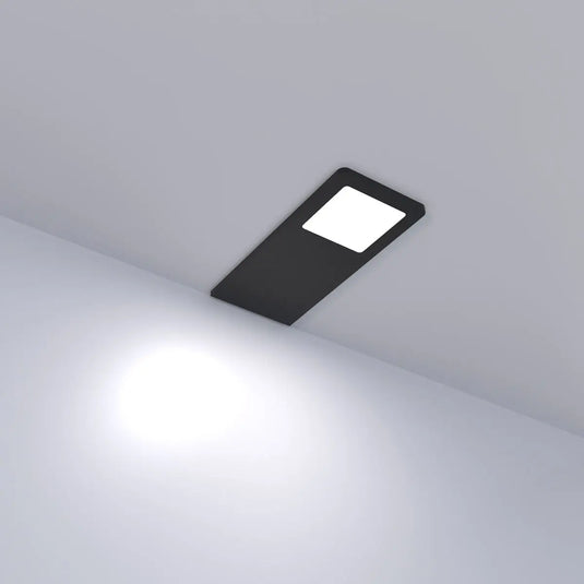 Black Recti Superslim 5w LED Cabinet Light, in natural white light lit, sideways angle