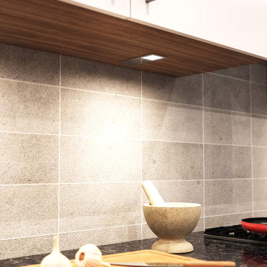 Natural white light on a worktop from a cabinet light above