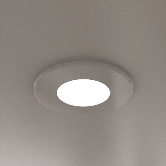 White fire rated downlight fitted in a ceiling
