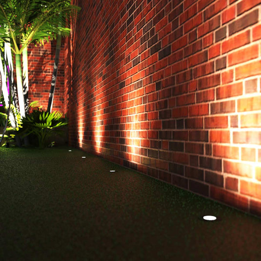 Side view of a garden walkway with ground lights