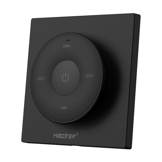 Black mini remote control on its magnetic plate