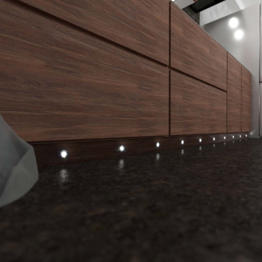Wooden kitchen cabinets with round plinth lights