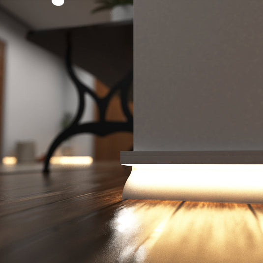Close up of white skirting profile lit in warm white