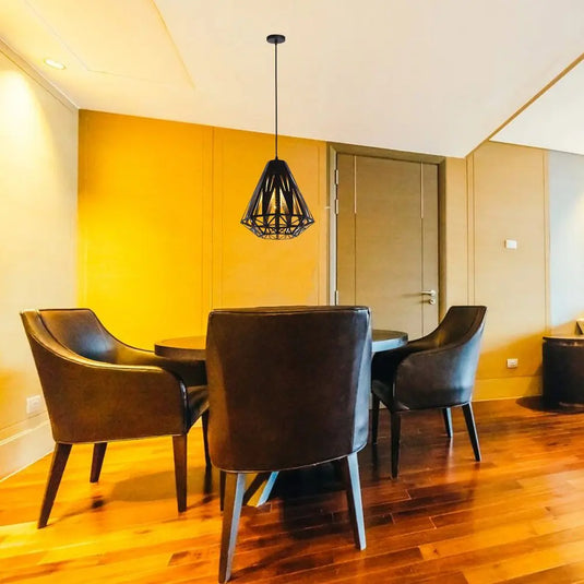 Black, Pendant Light In Black - Cage Design Mounted On Top Of a Dining Table Setting