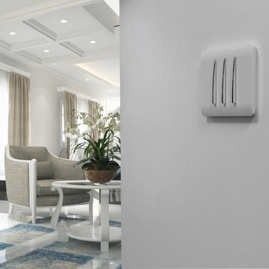 White 3 gang light switch fitted to a wall