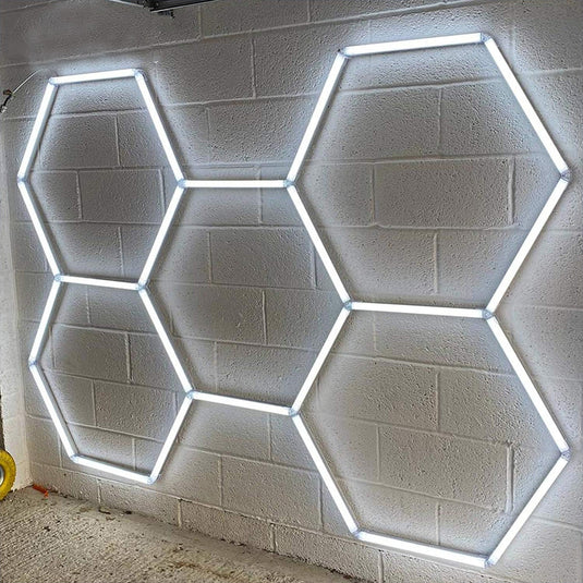 Hexagon LED tube kit lit up on a brick wall