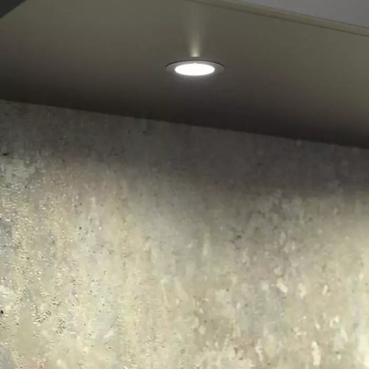 Close up of a mounted recessed type led cabinet light with warm white light