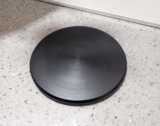 close up of the black top of a pop up electrical socket