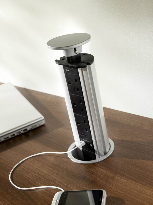 pop up socket with silver top and a charging white phone