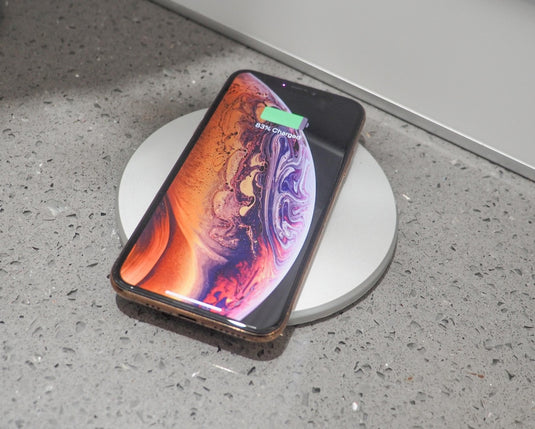 pop up electrical socket with a charging phone on the silver top