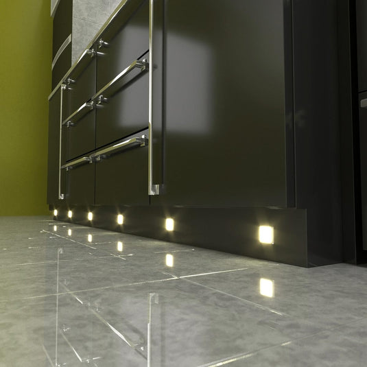 square LED plinth lights on a kickboard with a warm white light
