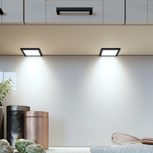 square under cabinet lights with black bezel in cool white light