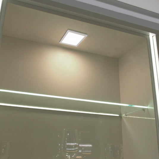 square slimline under cabinet light on a display shelf
