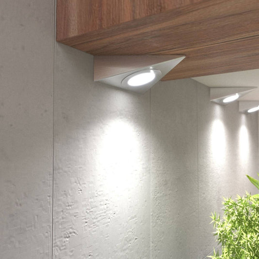 close up of mounted triangle under cabinet lights with natural white light