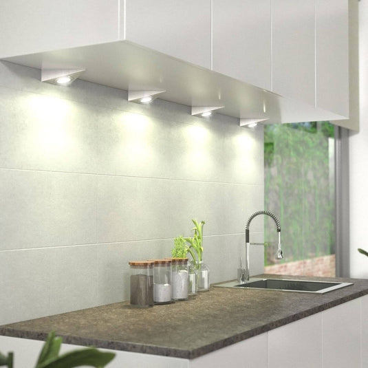 mounted triangle under cabinet light with warm white light under a kitchen cabinet