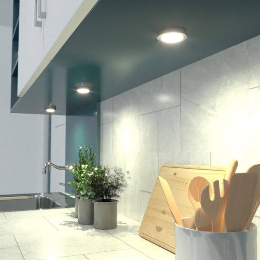 mid shot of a kitchen counter with mounted surface mounted under cabinet light with warm white light