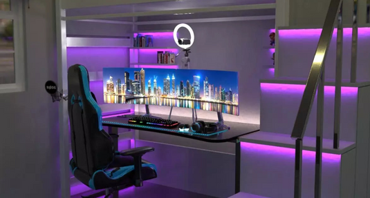 A gaming setup illuminated by LED strip lights.