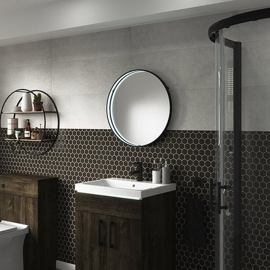 Aspect round LED mirror lit above a basin in a dark tiled bathroom