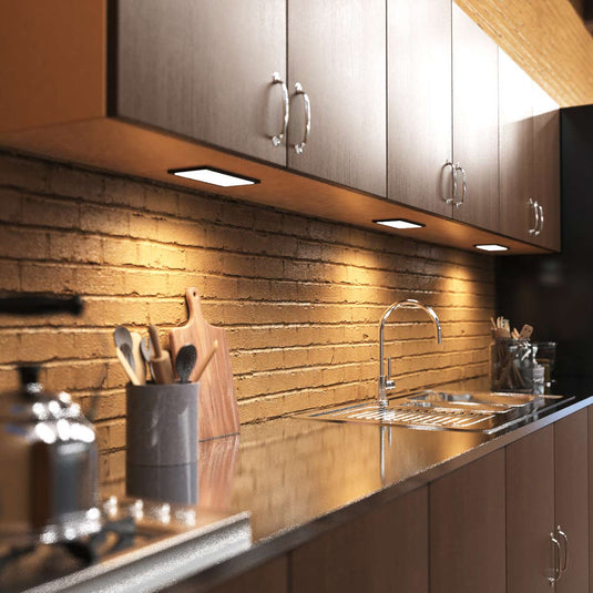 Kitchen counter lit by cabinet lights, full view