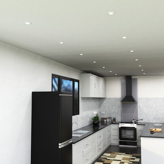 Side view of white downlights in a kitchen ceiling