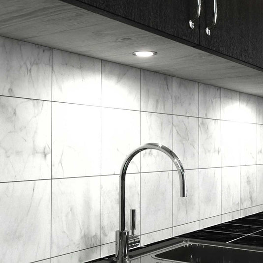 Kitchen cabinets with natural white recessed under cabinet lights