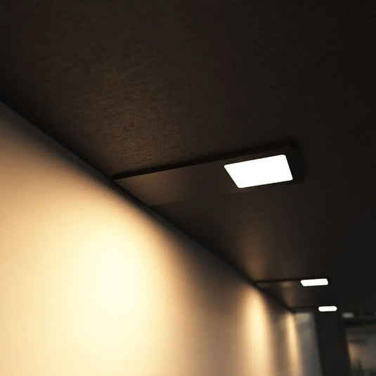 Black Recti Superslim 5w LED Cabinet Light, mounted under cabinet in warm white light side shot