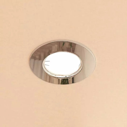 Chrome GU10 Fire Rated Downlight in warm white light mounted in ceiling