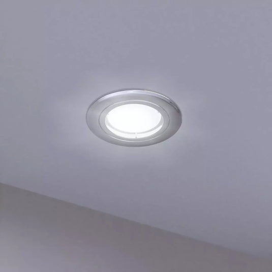 Chrome, Fixed GU10 Fire-Rated Downlight mounted in the ceiling in cool white light