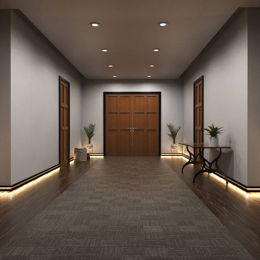 Entryway with black skirting profile lit in warm white
