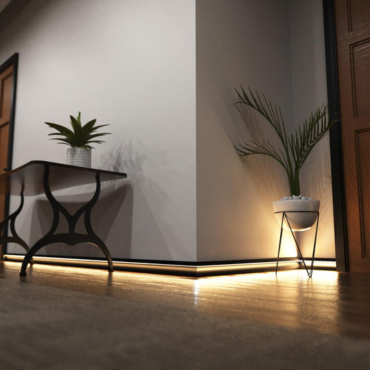 Hallway with black skirting profile lit in warm white