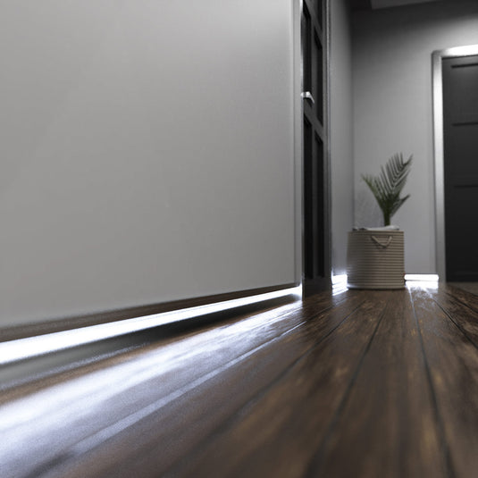 Hallway with silver skirting profile lit in cool white