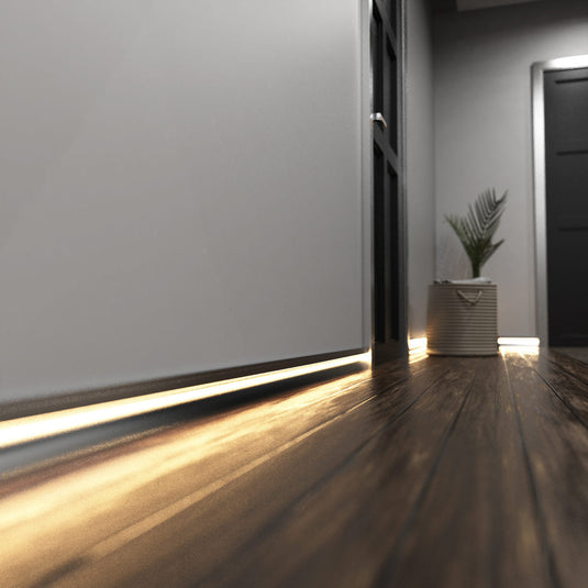 Hallway with silver skirting profile lit in warm white
