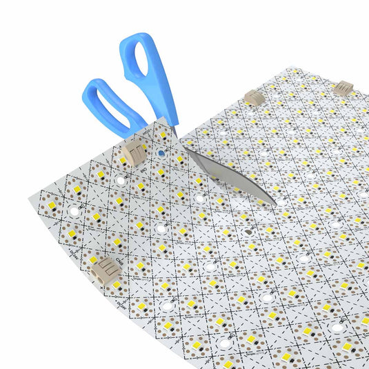LED sheet being trimmed with scissors