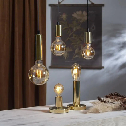 Smart WiFi Filament Bulb in warm white light, above and on top of the table setting