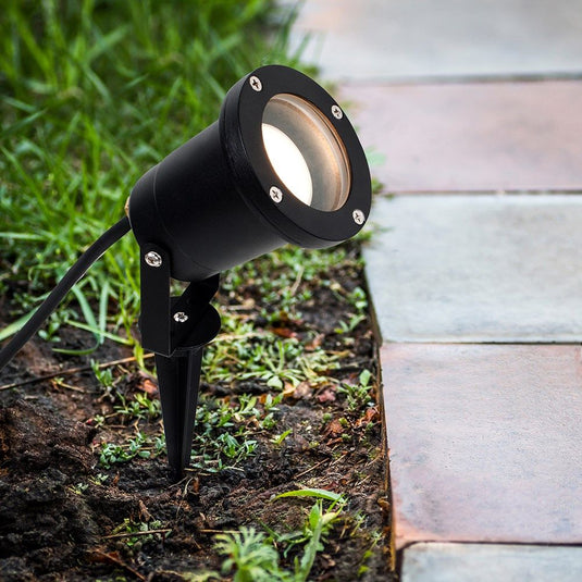 Black LED spike light planted on the ground