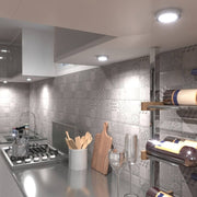 kitchen cabinet with round surface-mounted under cabinet lights in cool white light