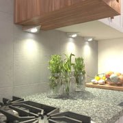 mid close up of mounted triangle under cabinet lights with warm white light